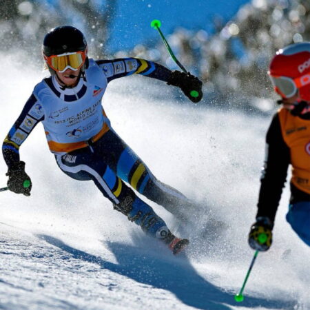 An exciting photo of a vision impaired skier and his guide heading down the mountain at the 2013 IPC Alpine Skiing Wold Cup.