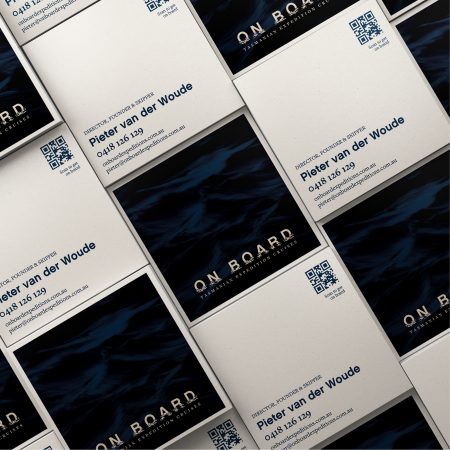 A group of business cards showing the front and back designs with the inky blue water and logo